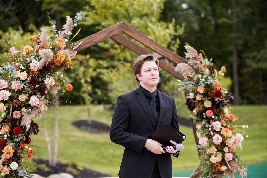 Reed waiting at the floral arch before the ceremony